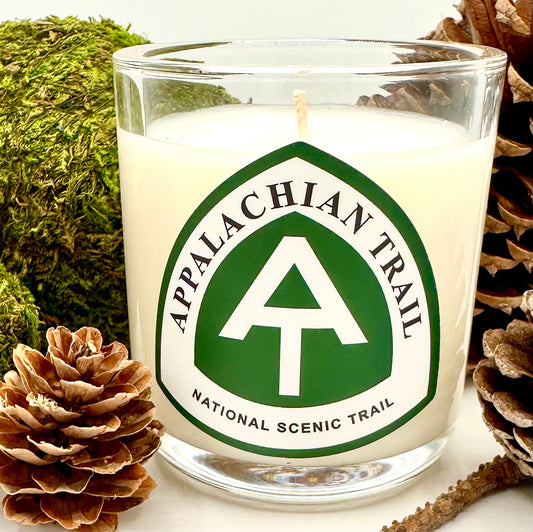 petite white candle in glass vessel featuring the Appalachian Trail logo in white and green