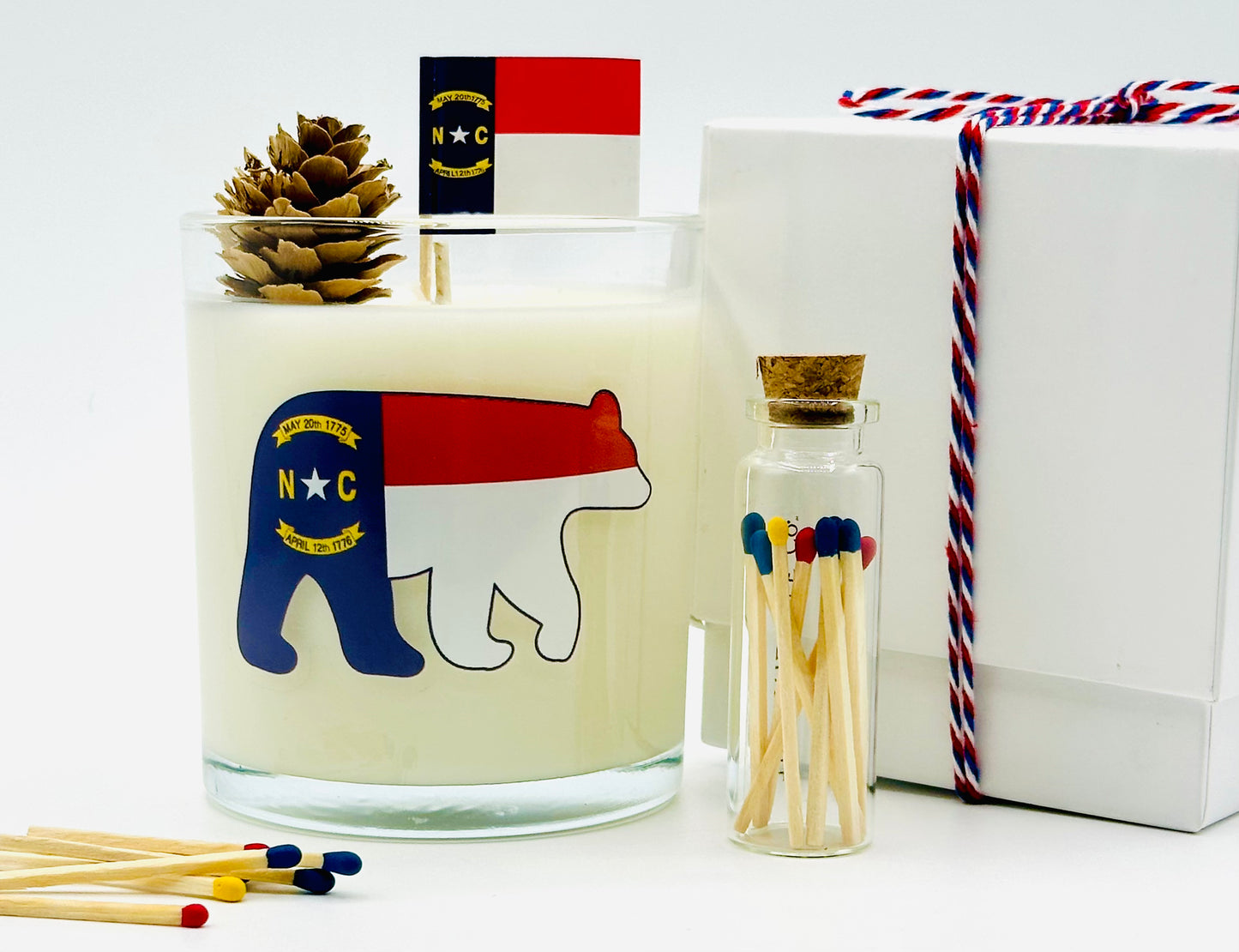 North Carolina Sweet Tea Luxury Candle | No. 1789 - The ASHEVILLE Co.™ with NC Flag Bear and Pinecone with North Carolina Flag with red, blue, yellow matches Match jar and gift box with ribbon