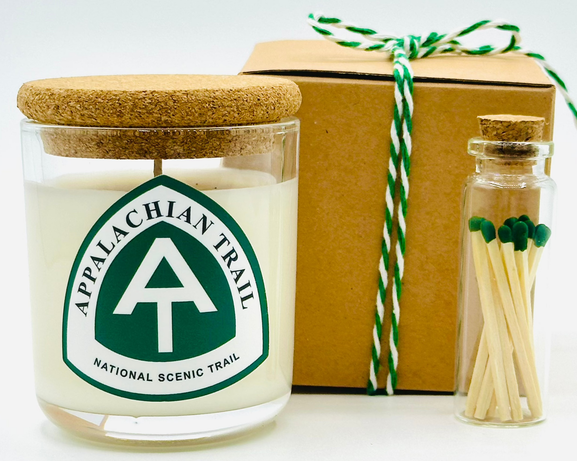 AT candle presented with gift box with white and green twine and green matches  