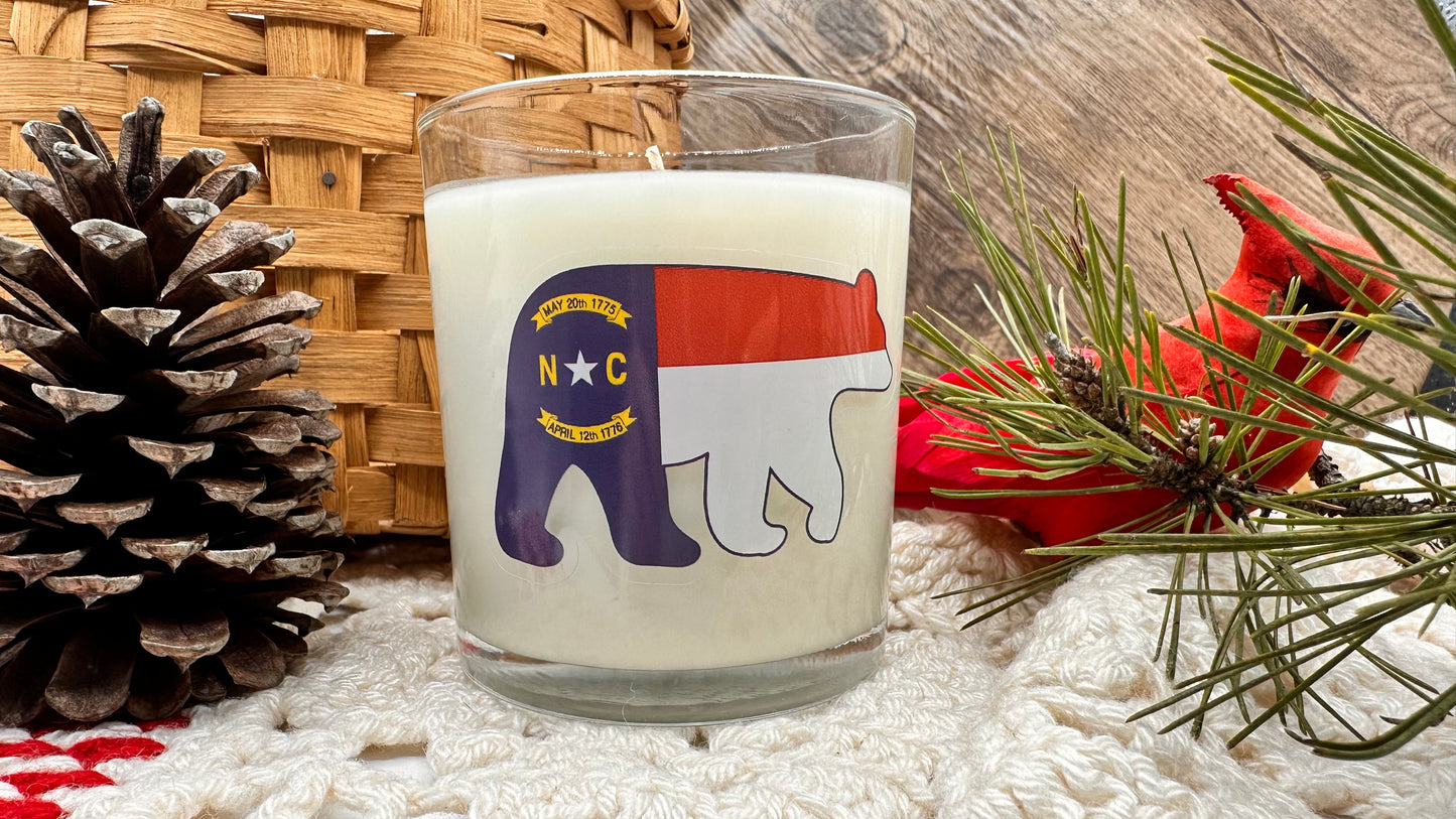 North Carolina Sweet Tea Luxury Candle | No. 1789 - The ASHEVILLE Co.™  with cardinal bird pine cone and woven basket 